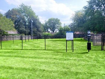 A sign is posted on a fence in a grassy field at Townhomes at 28th, Indiana, 47201